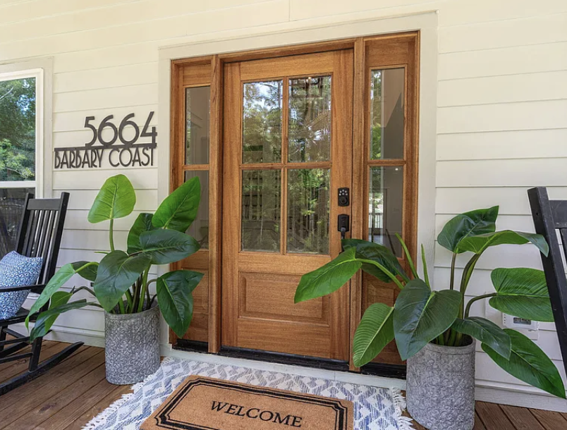 Front entry with glass-paneled door and sidelights