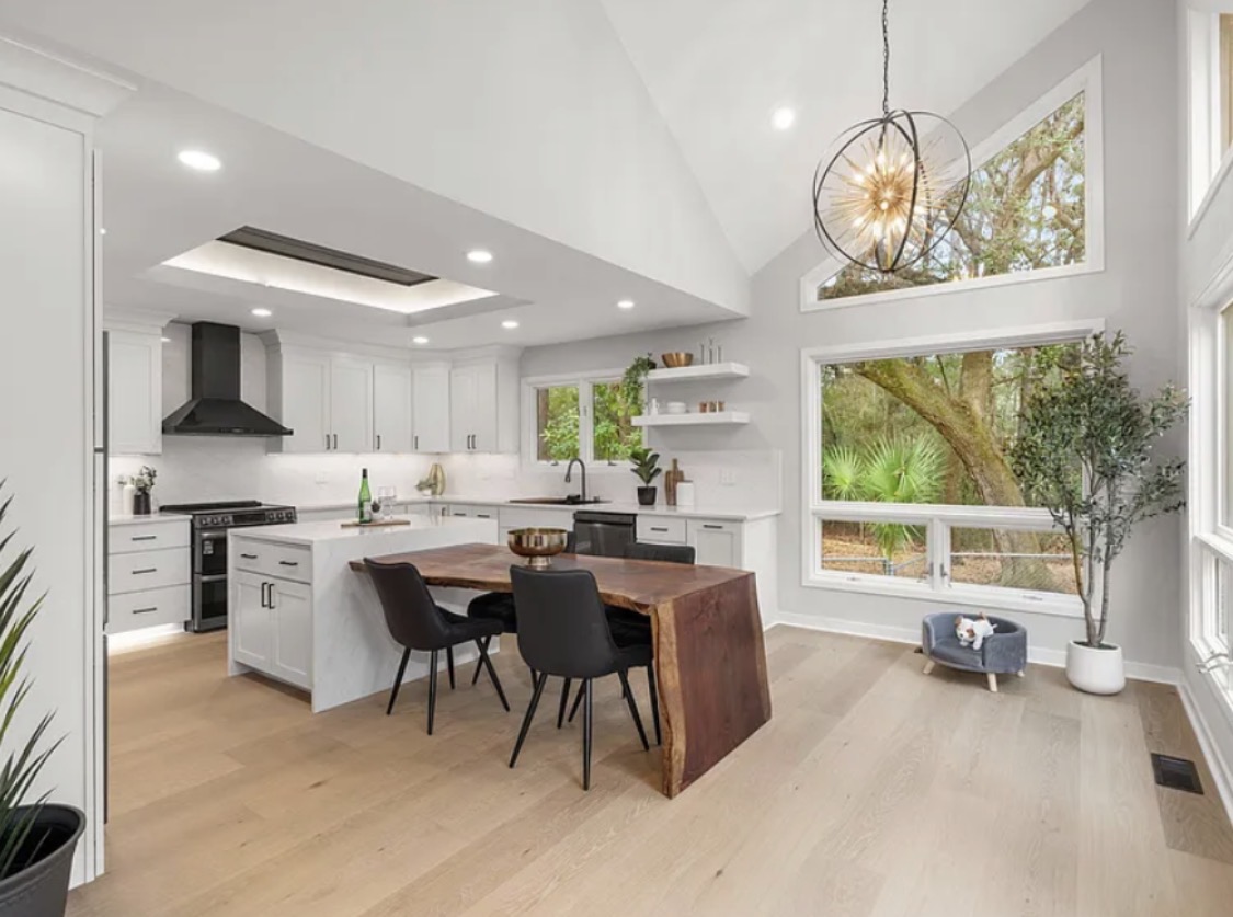 Kitchen island with live-edge dining table and starburst chandelier
