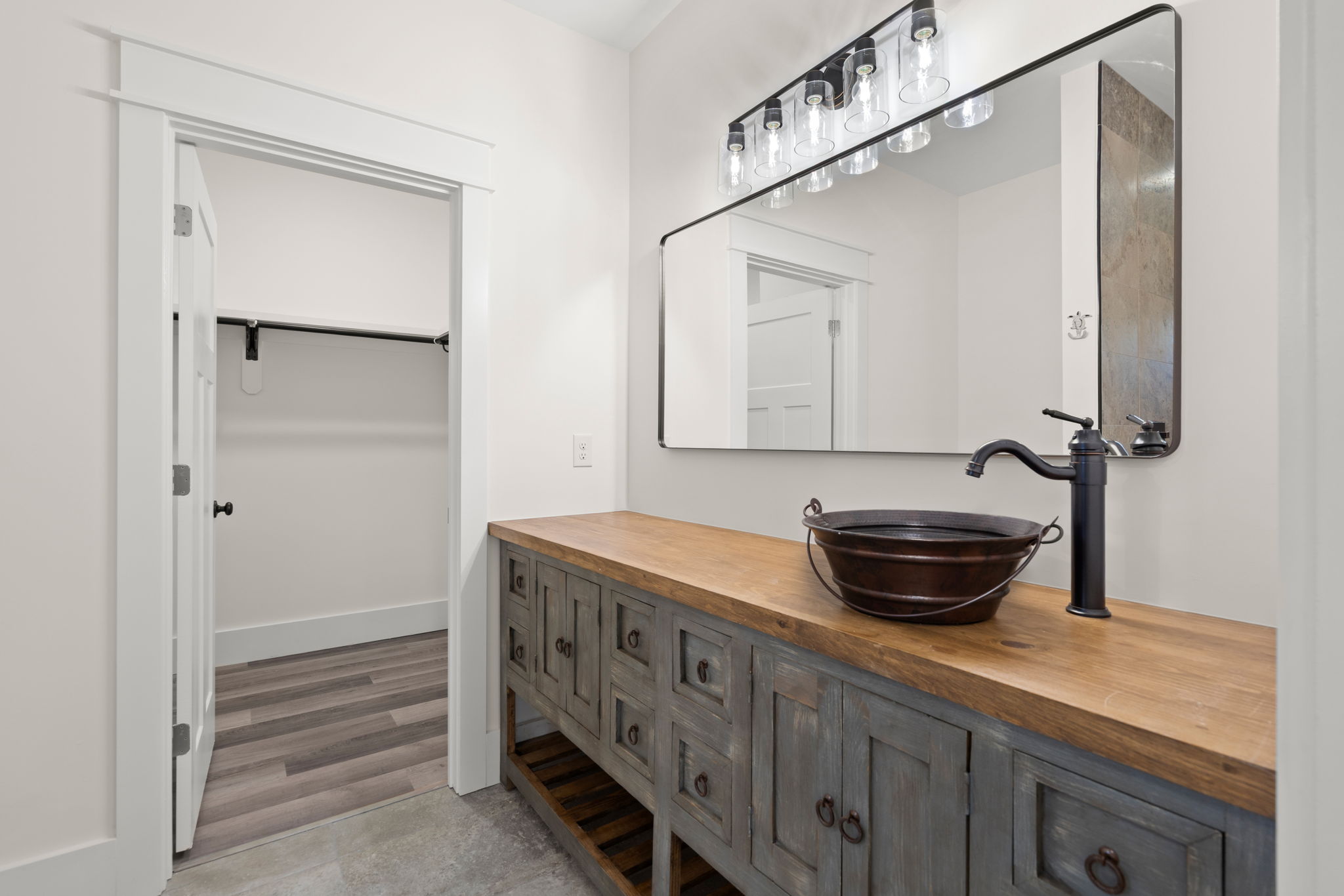 Bath vanity with wood counter and black vessel sink