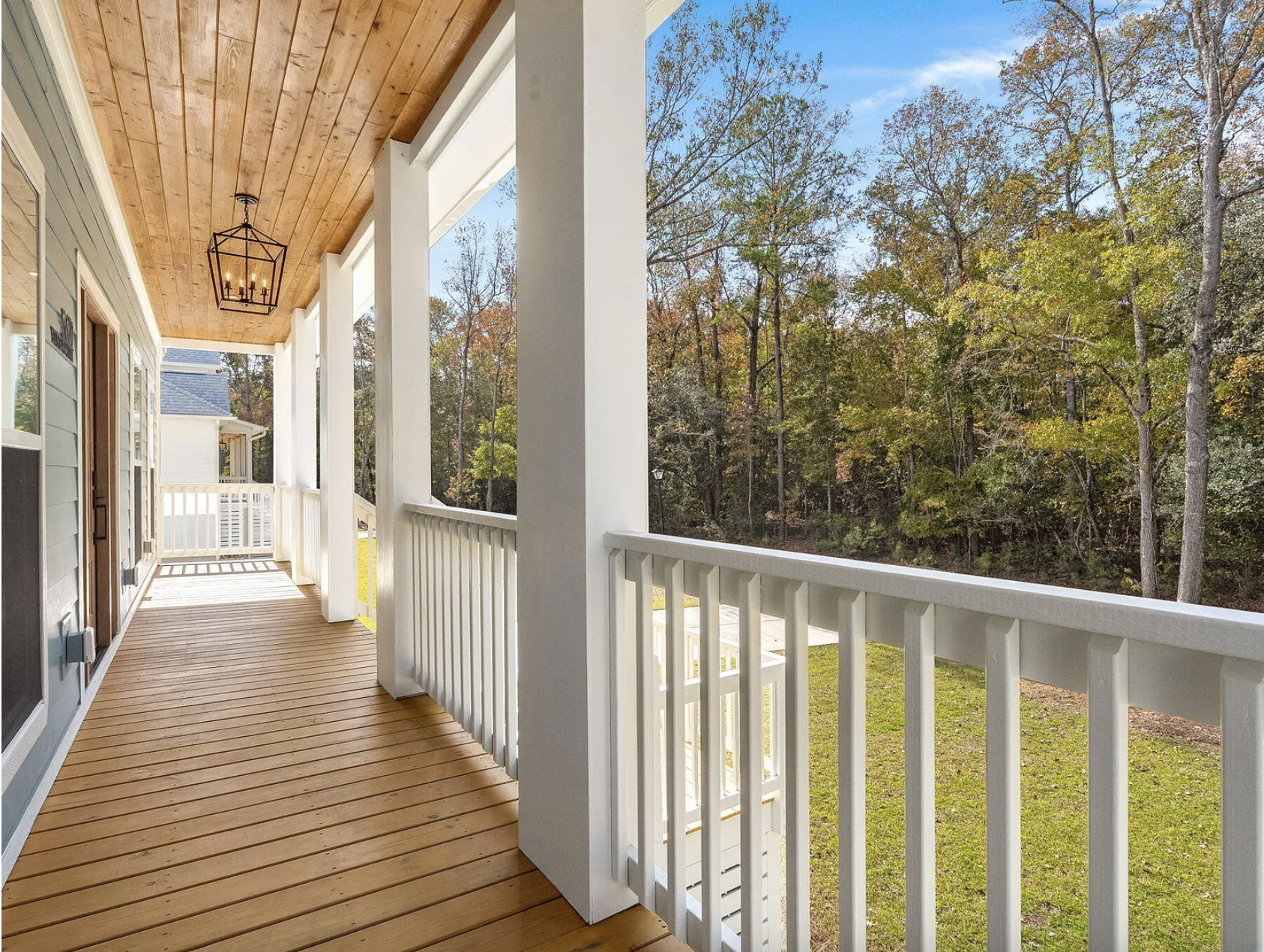 Covered porch with white columns and lantern fixture