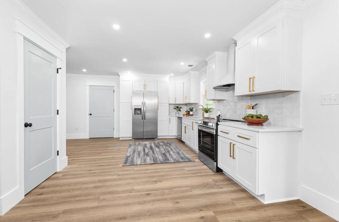 Kitchen with sage accents and blue geometric rug