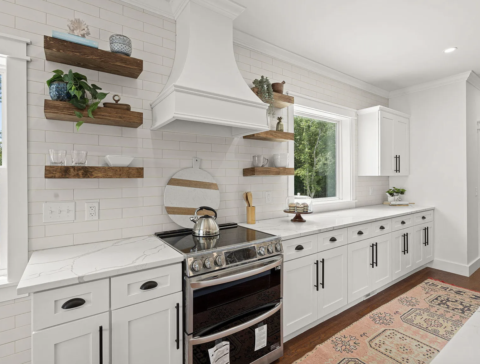 Kitchen range wall with subway tile and wood floating shelves