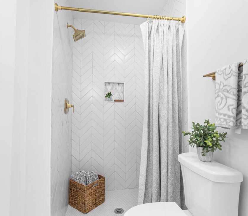 Ensuite walk-in shower with chevron tile and gold fixtures