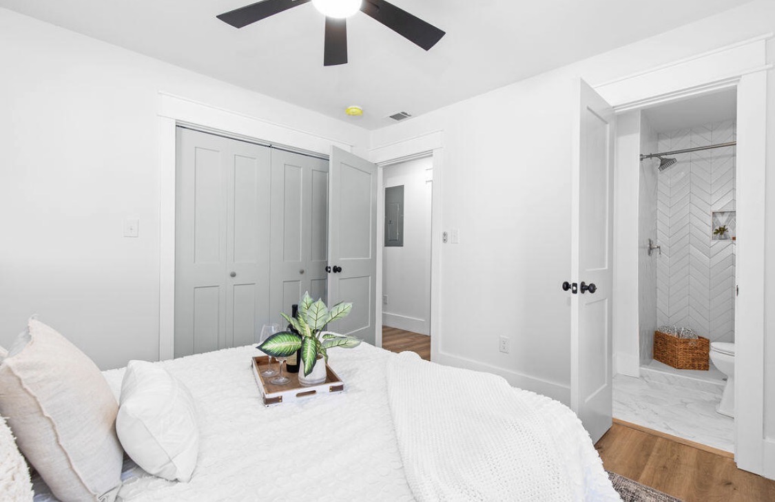 Guest bedroom with herringbone-tile ensuite visible