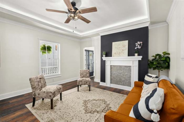 Living room with cognac sofa and charcoal fireplace wall