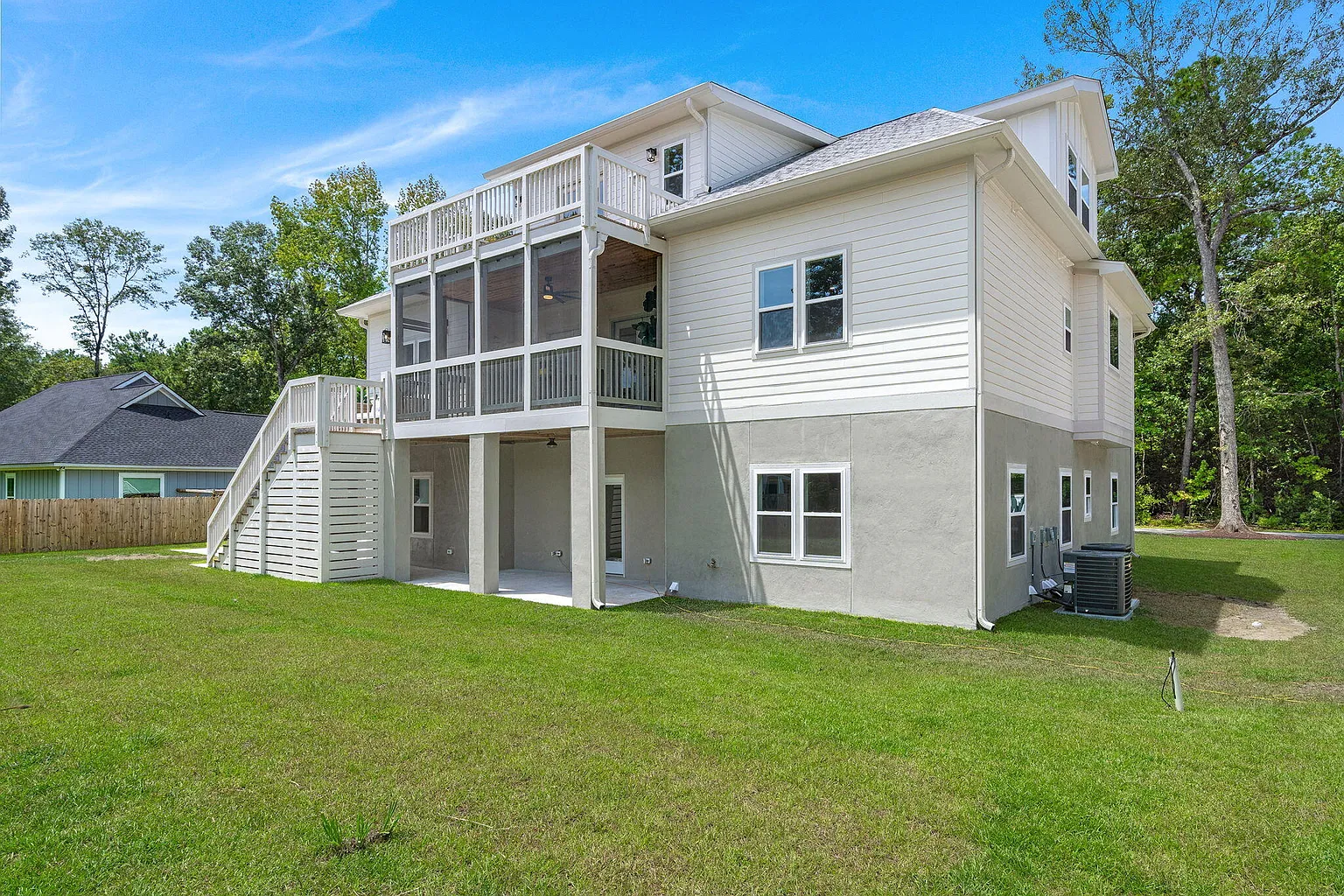 Rear view with two-story screened porch and exterior staircase