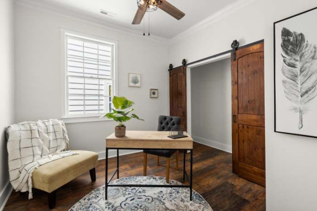 Home office with barn doors and feather art