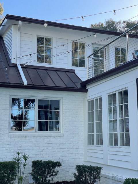 Corner detail with cable-railed balcony and globe string lights