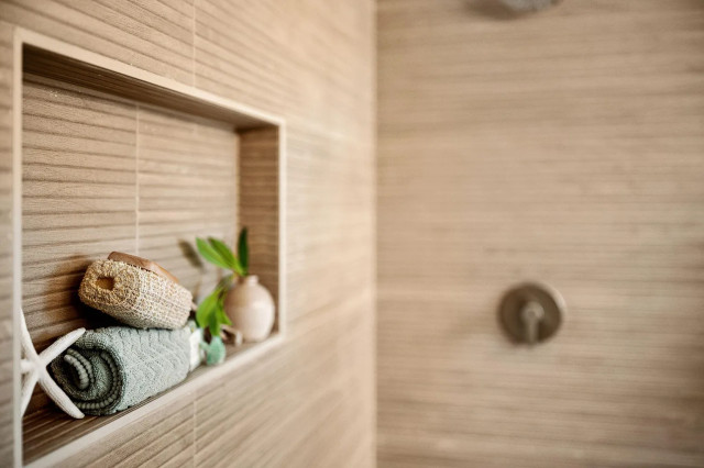 Shower niche detail with brass fixtures