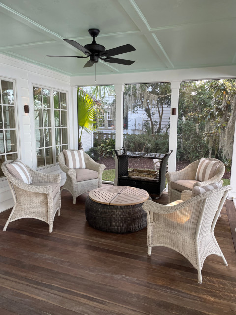 Screened porch seating with mint-green paneled ceiling
