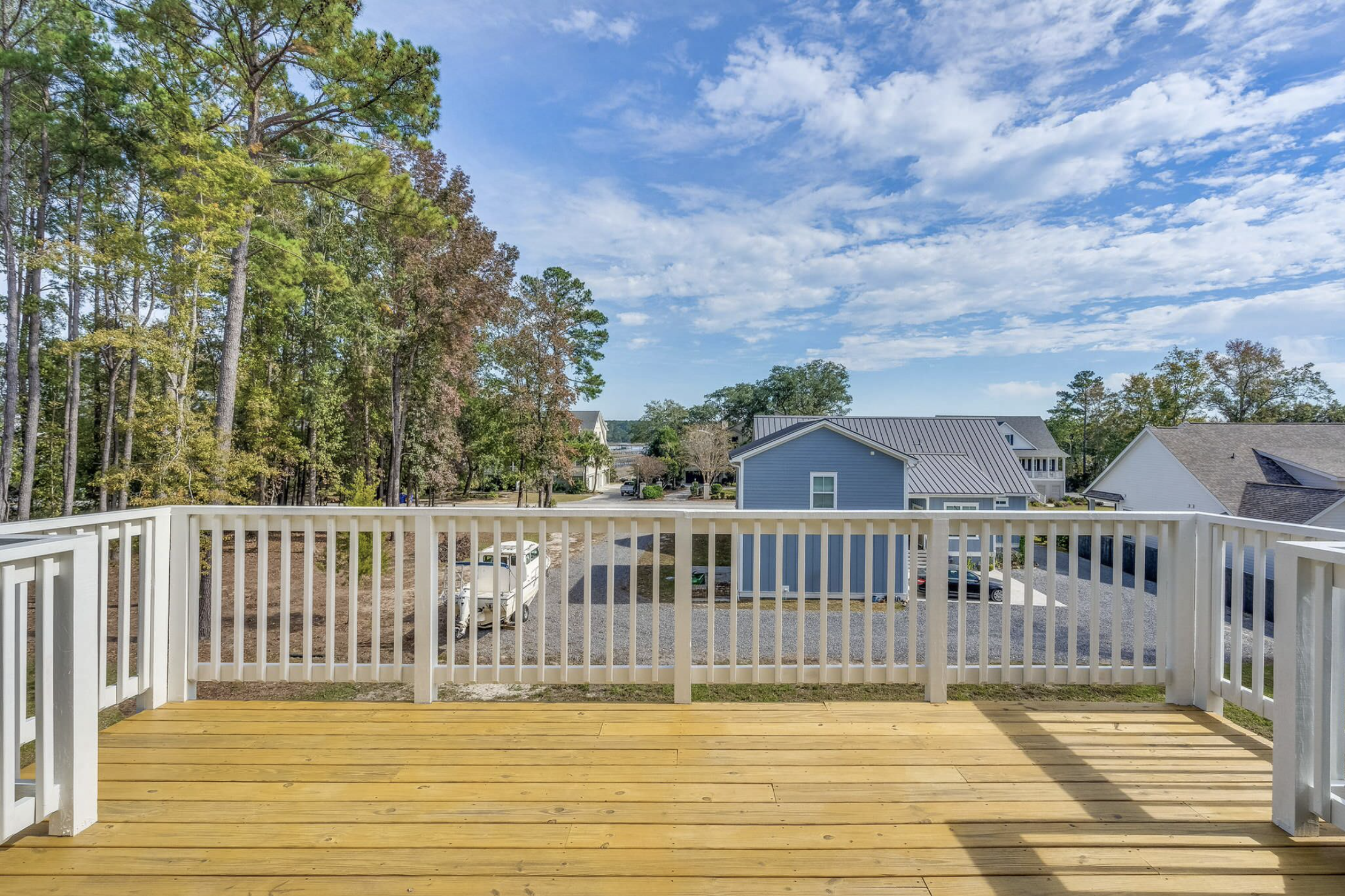 Wood deck with white railing overlooking the yard