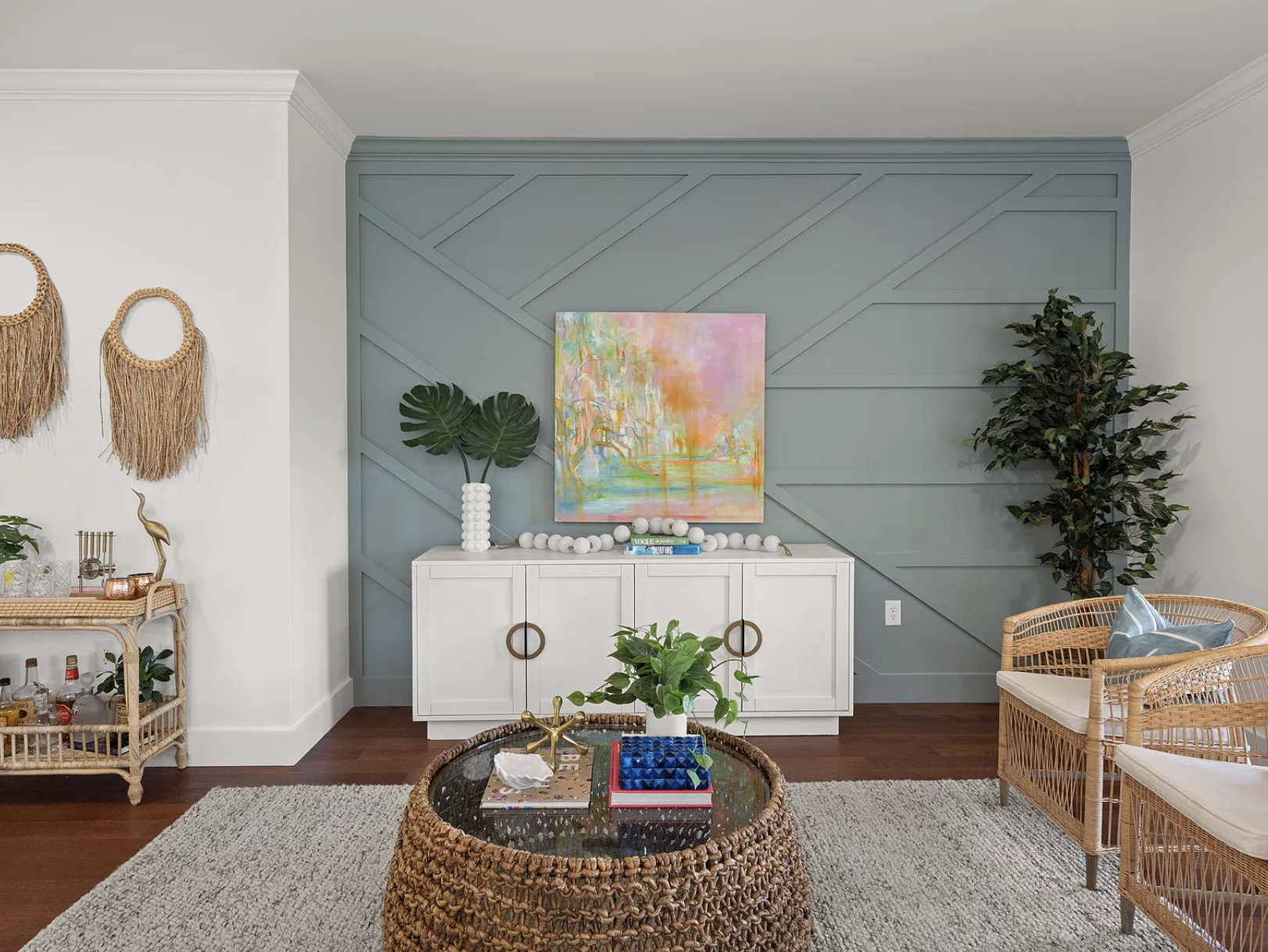 Sage-green geometric accent wall with abstract painting
