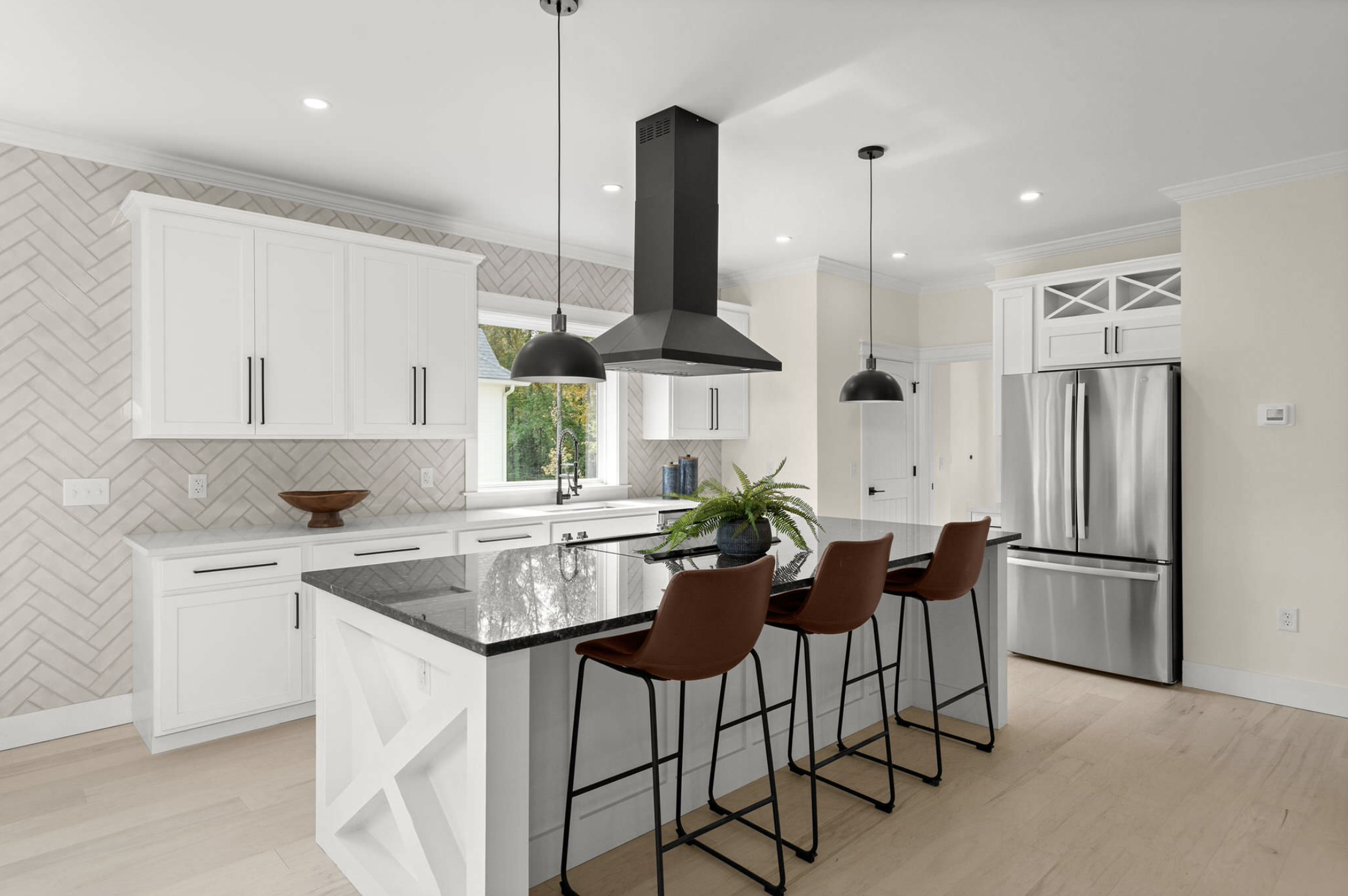 Kitchen island with dome pendants and black range hood