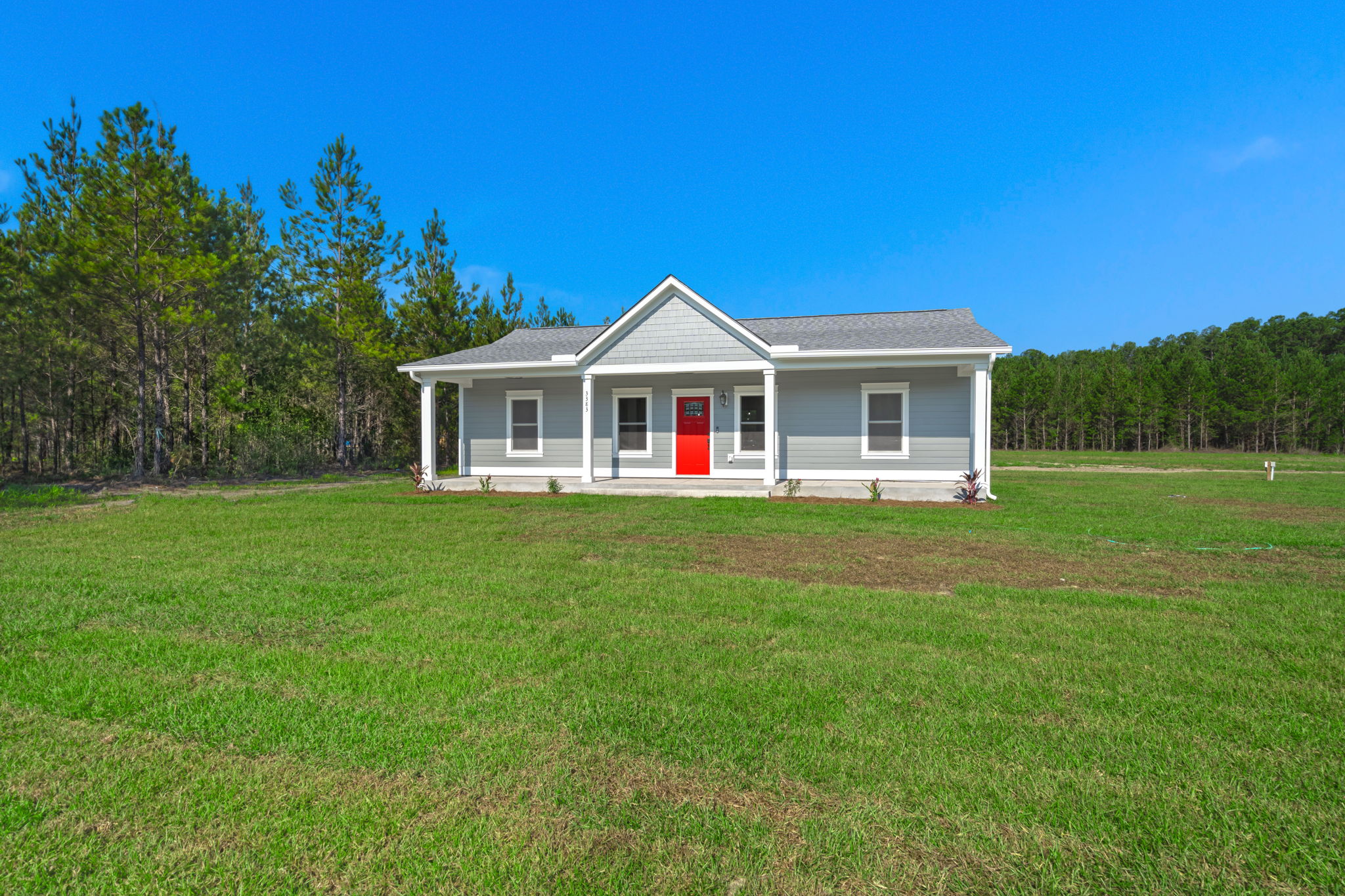 Front elevation with shake-shingle gable and red door