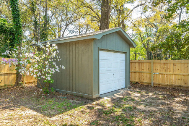 Olive green detached garage with board-and-batten siding