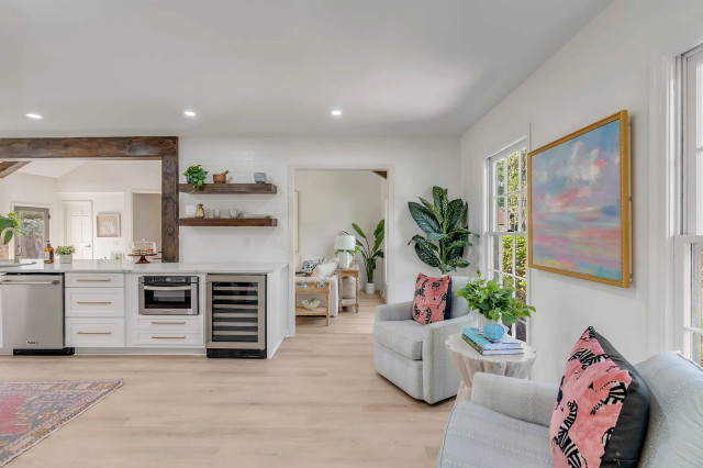 Kitchen to living transition with beam framing and abstract art