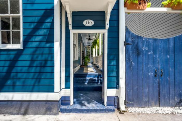 Entry gate with America St plaque and hanging planters