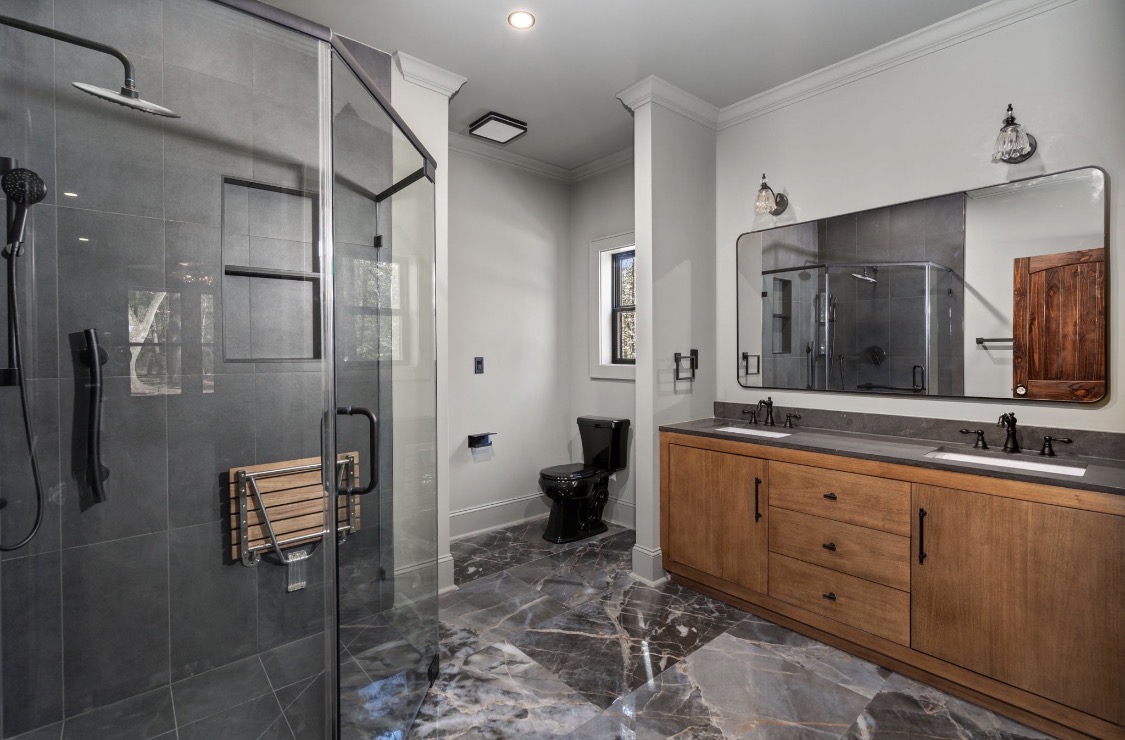 Primary bathroom with glass shower and double vanity