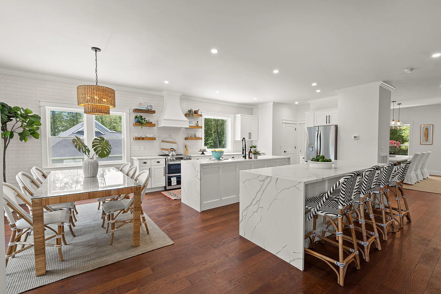 Kitchen and dining area with waterfall island and floating shelves