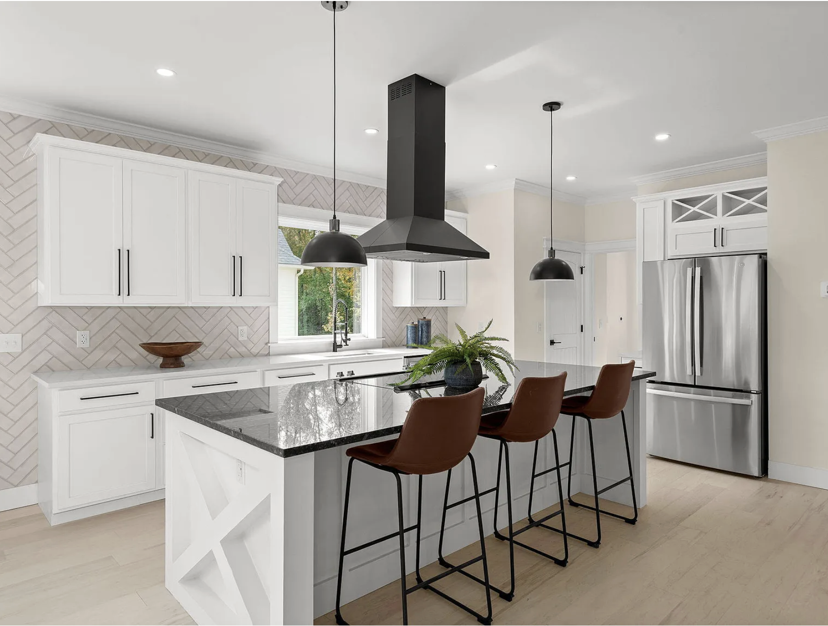 Kitchen with black granite island and leather stools