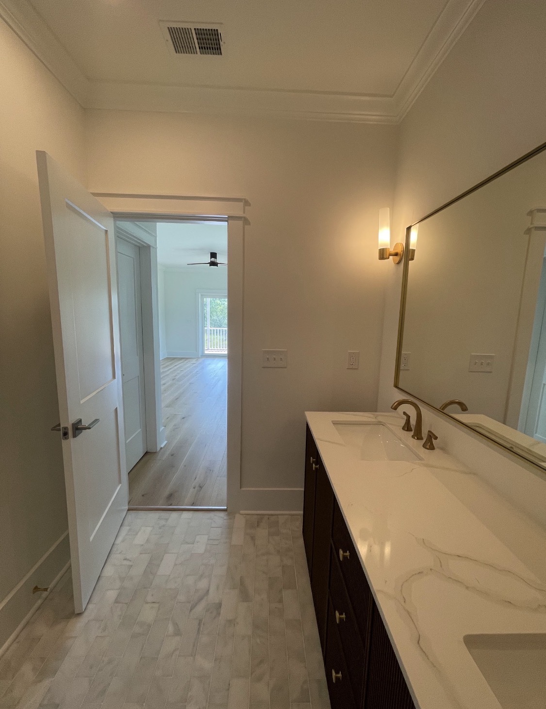Bathroom with dual-sink vanity and gold hardware
