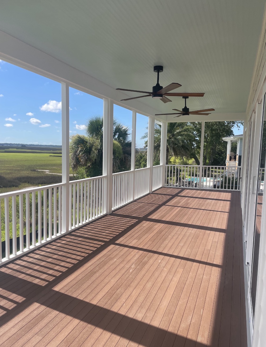 Screened porch with haint-blue ceiling and marsh views