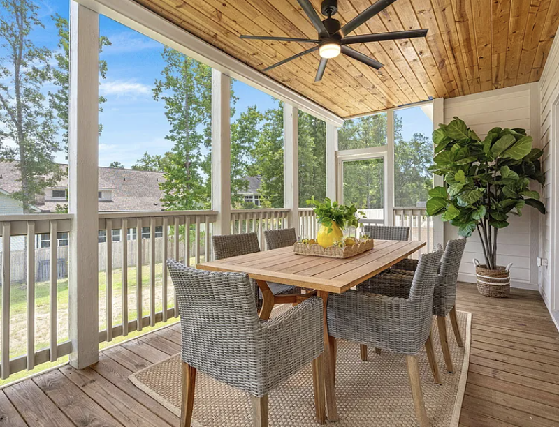 Screened porch dining area with wood-planked ceiling