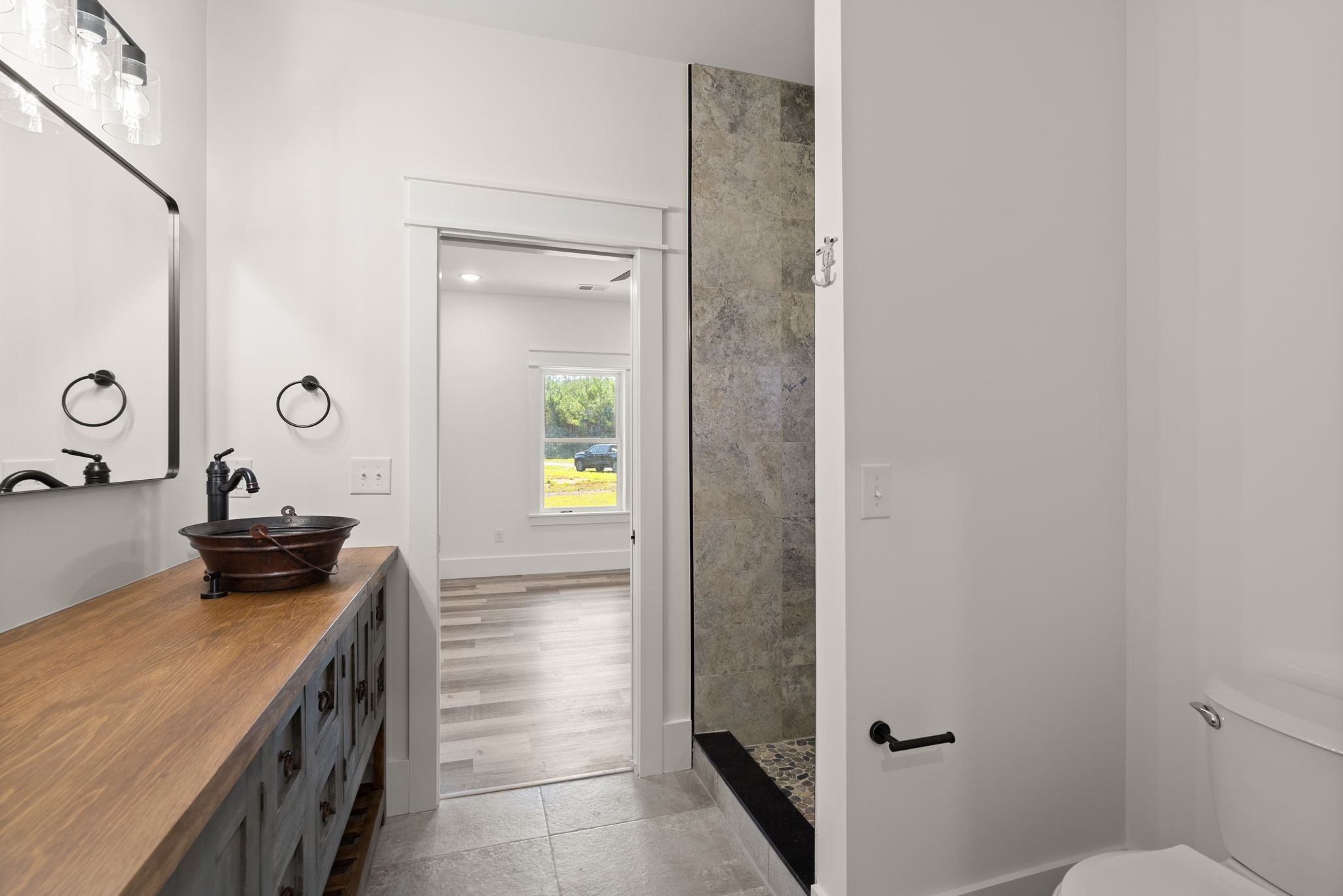 Bathroom from the doorway showing vanity, shower, and toilet