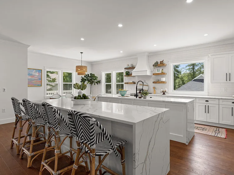 Breakfast area with woven pendant over dual kitchen islands