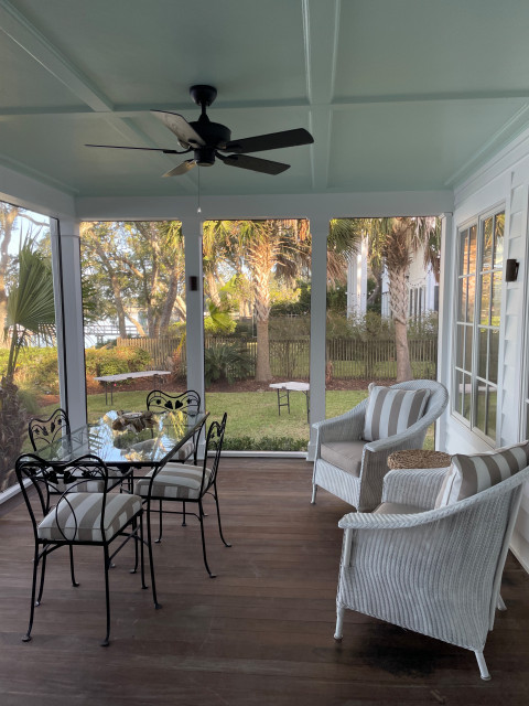 Screened porch dining area with black metal table