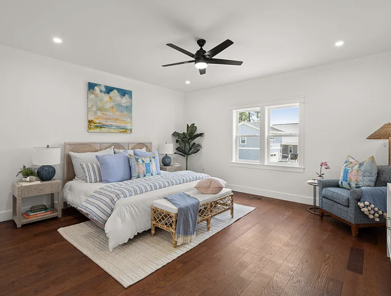Primary bedroom with arched headboard and blue accents