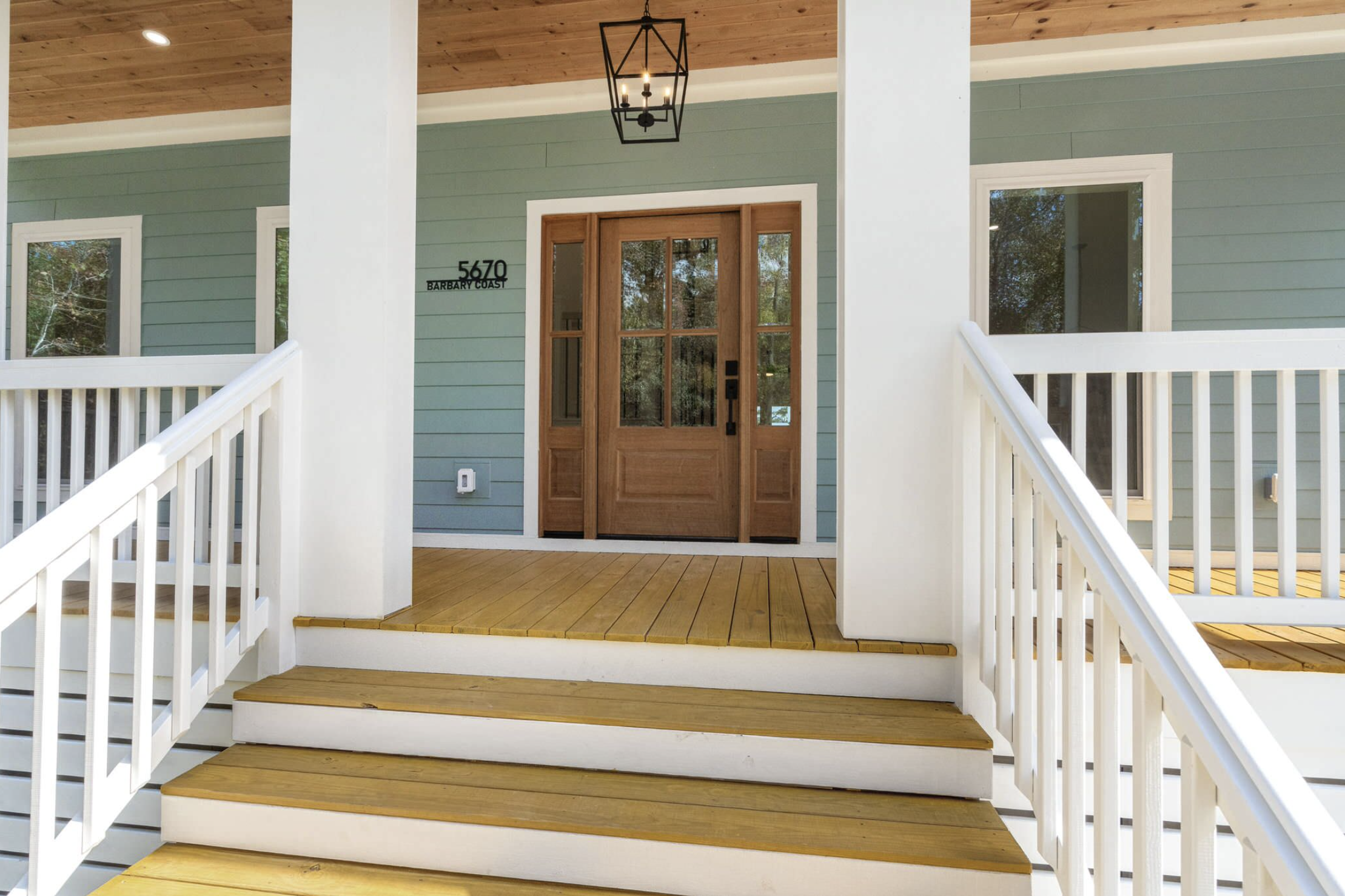 Front entry with wood porch and hanging lantern