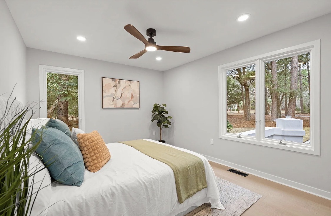 Bedroom with sage accents and wooded views