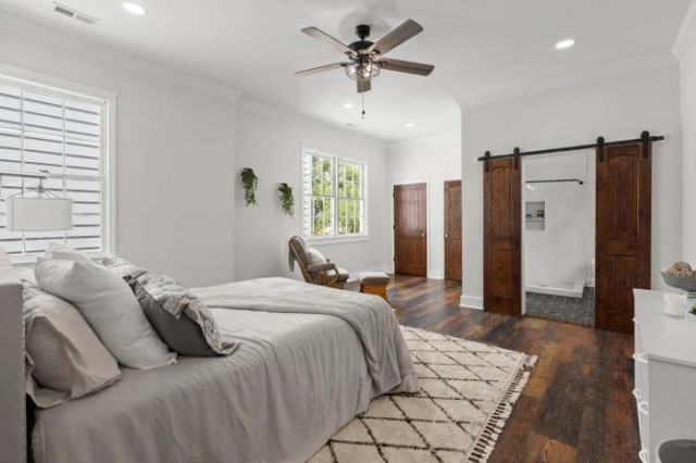 Guest bedroom with barn doors to ensuite bath