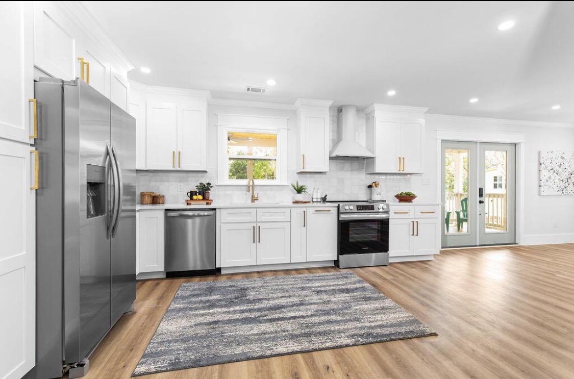 White shaker kitchen with brass hardware and subway backsplash