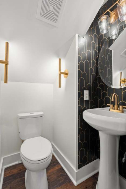 Powder room with black-and-gold arched wallpaper