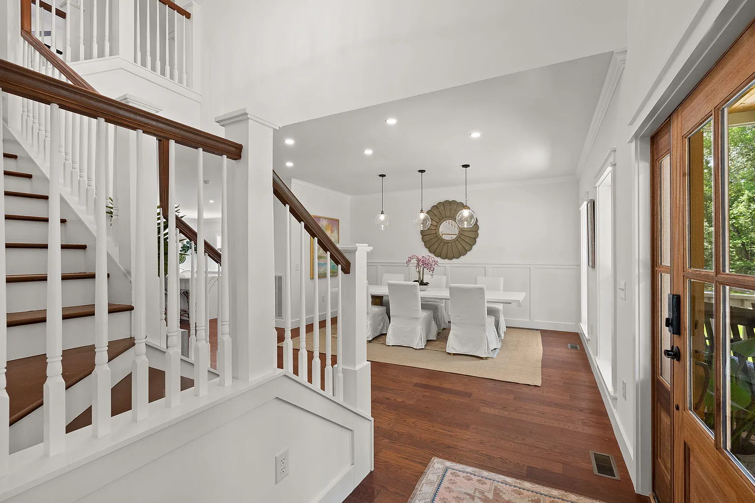 Entry hall with staircase and formal dining area