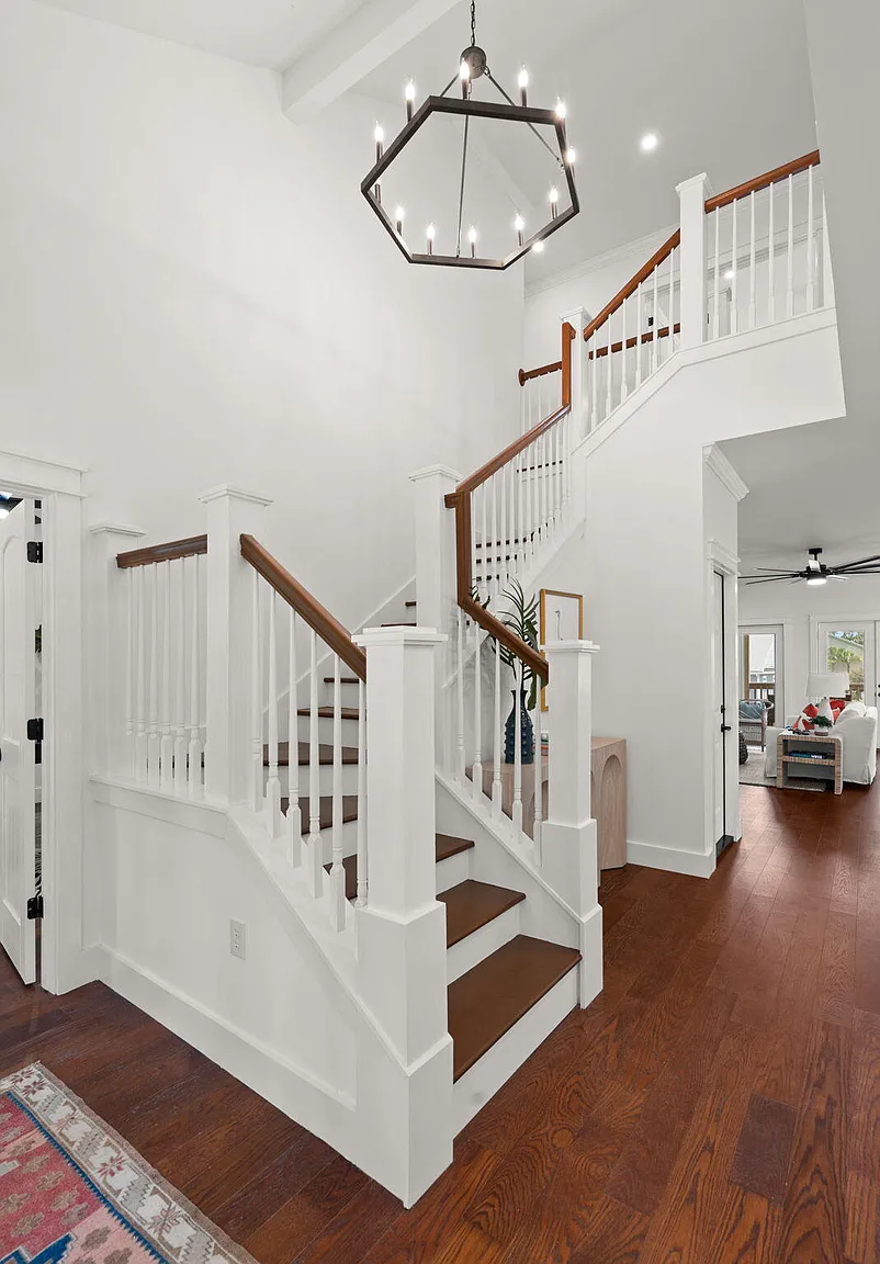 Foyer with staircase and hexagonal pendant chandelier