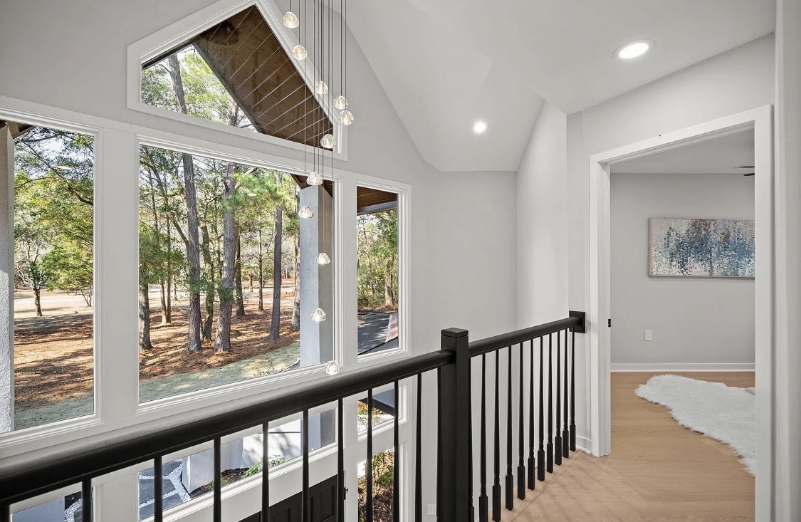 Upstairs landing with gable windows and cascading pendant light
