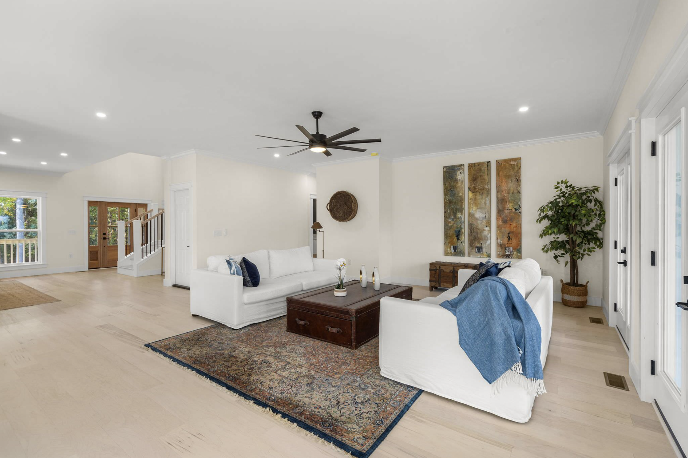 Living room with white sofas and open floor plan