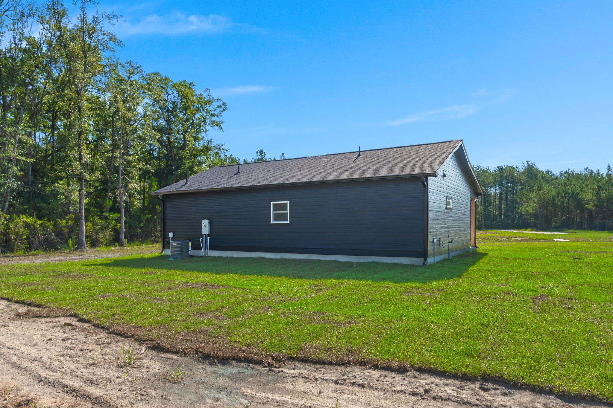 Side profile of the dark-sided home with white trim