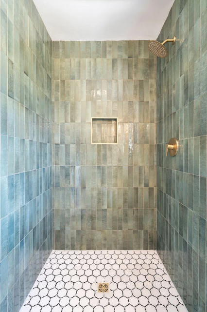 Guest shower with glossy teal tile and brass niche trim
