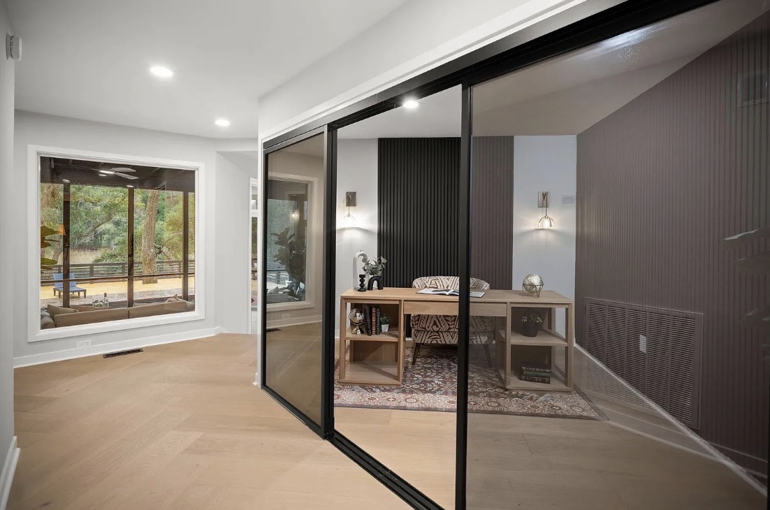 Home office viewed from the hallway through glass doors