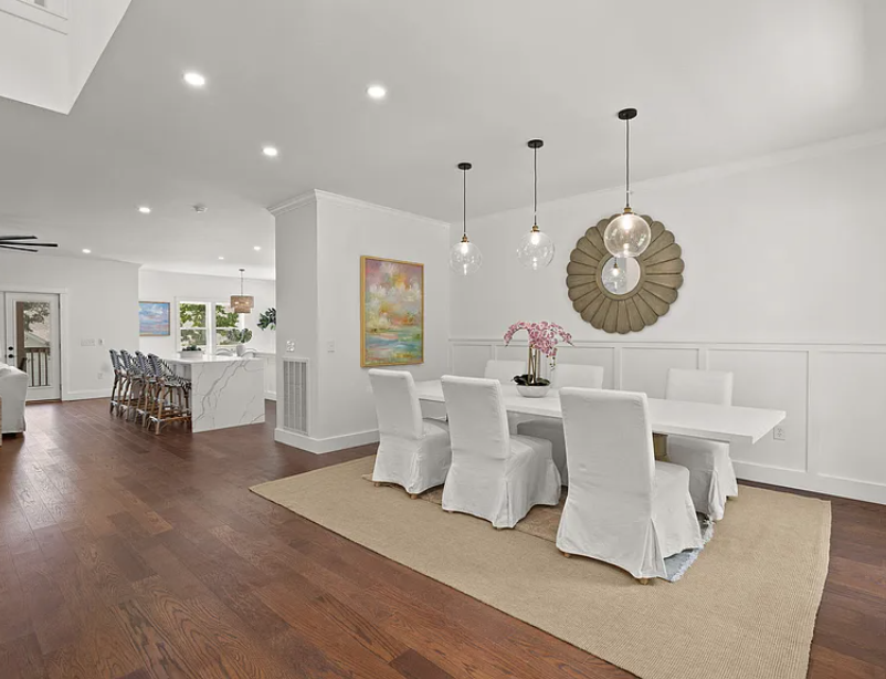 Formal dining room with glass globe pendants and wainscoting