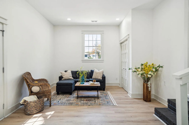 Lounge with charcoal sectional and wicker accent chair