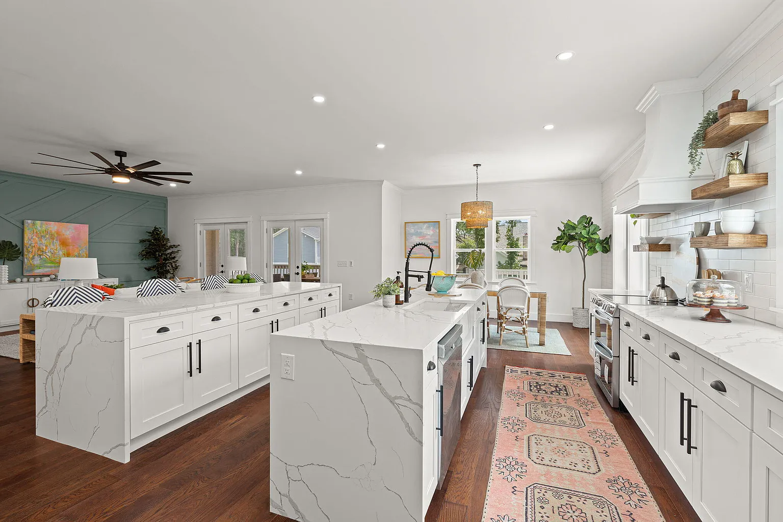 Dual-island kitchen with farmhouse sink and pantry beyond