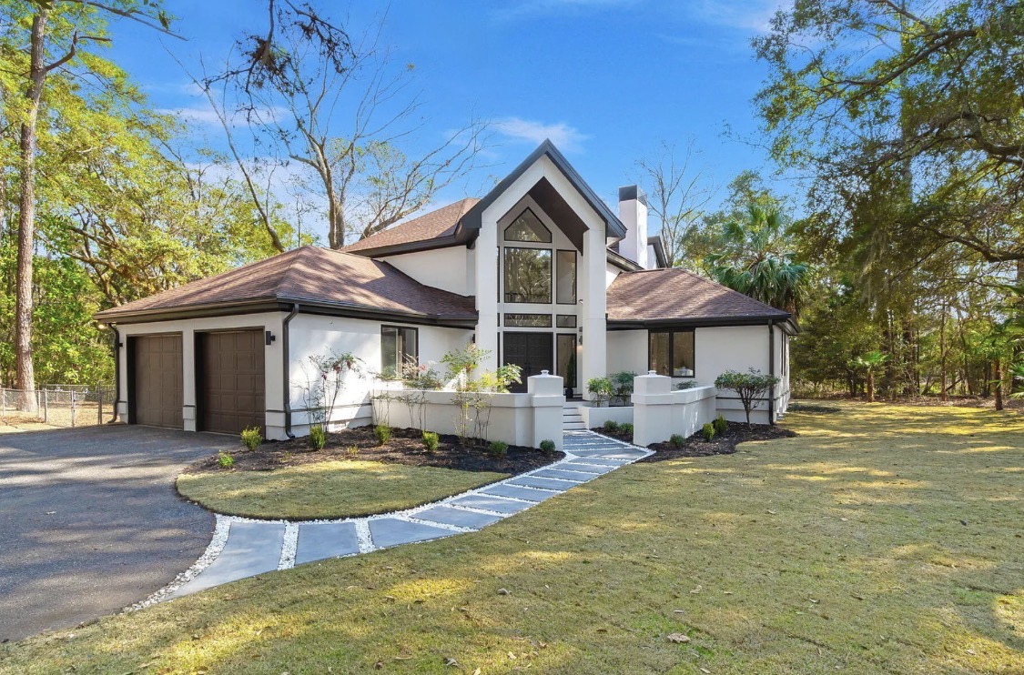 Street view of the white two-story home with attached garage