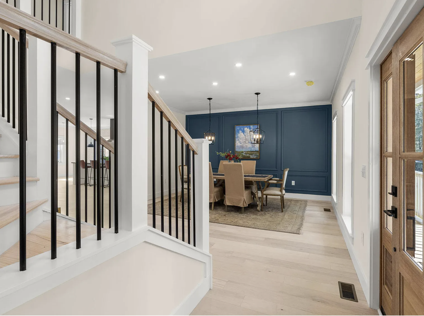 Staircase view across entry into dining room
