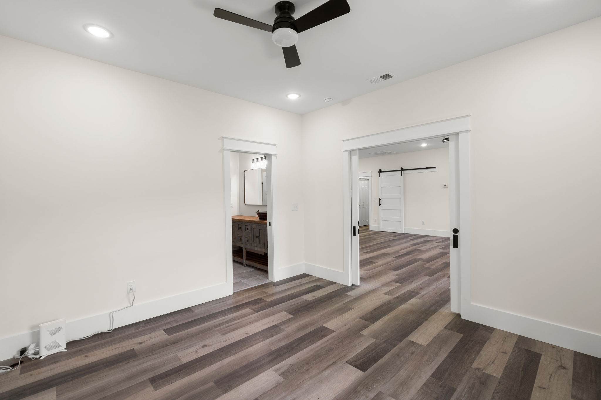 Hallway with views to the bath vanity and living area