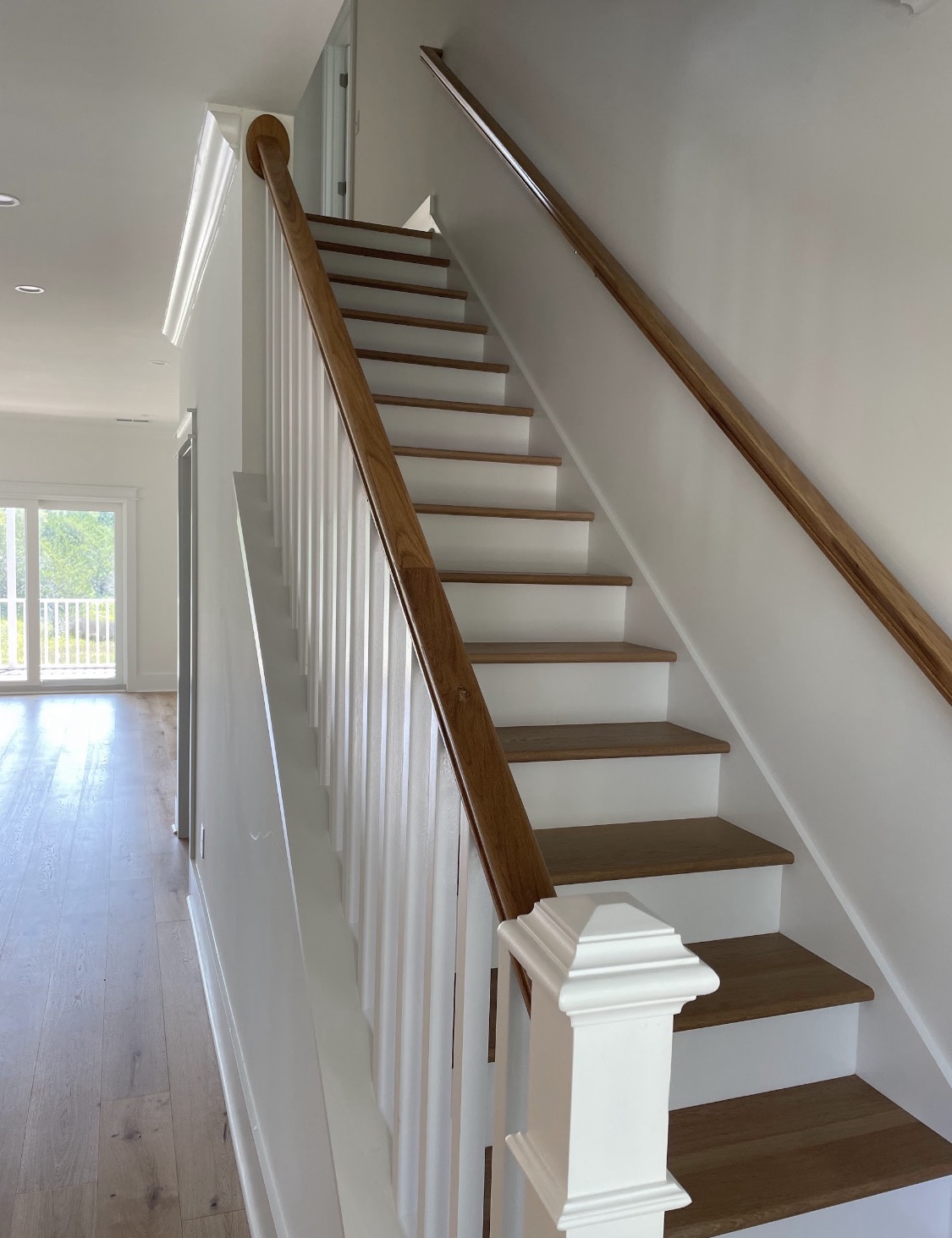 Custom staircase with stained treads and white balusters